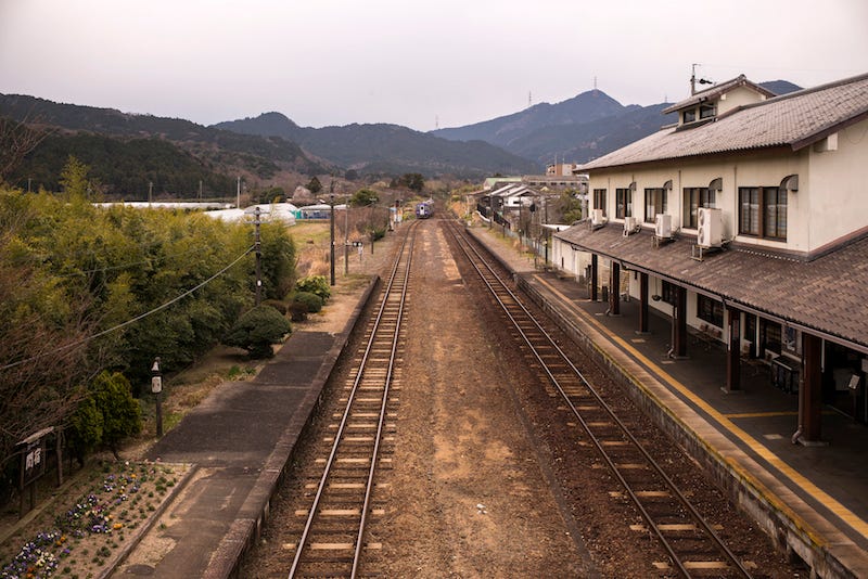 A tourist traveling in the Japanese countryside arrives at a rural train station