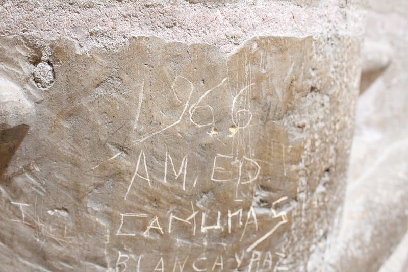 Names and the year 1966 inscribed on stone in a cathedral in Segovia, Spain