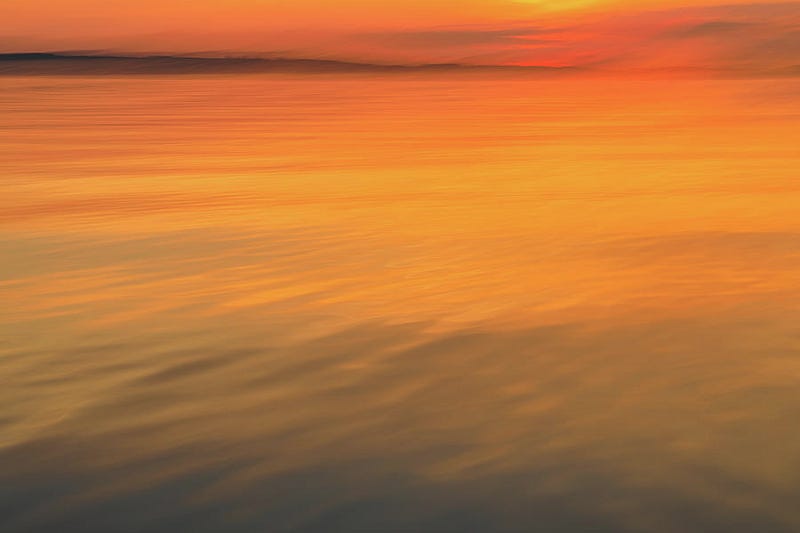 Abstract motion blur photograph of a colorful sunset horizon, emphasizing streaks of light and textured sky — fine art by Dan Sproul.