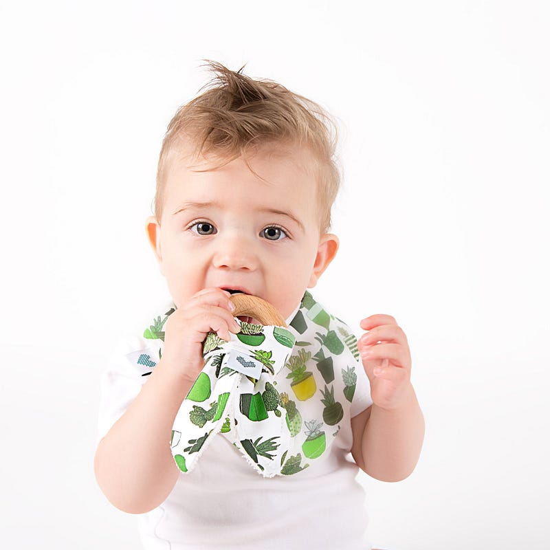 Boy using wooden natural teething toys