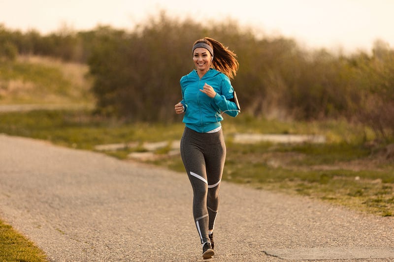 A young girl running a marathon or a race enjoying her strides on a lovely morning