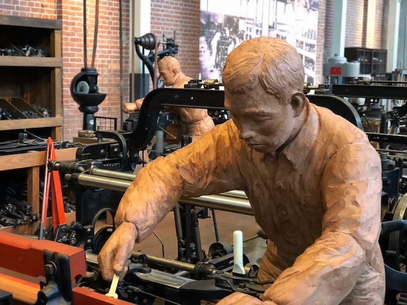 Statues of men work on machinery at Toyota Commemorative Museum of Industry and Technology in Nagoya