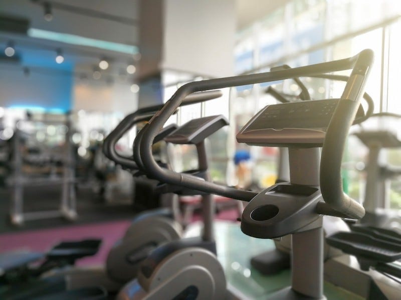 A traveler sneaks in a workout at the hotel gym while traveling in Japan