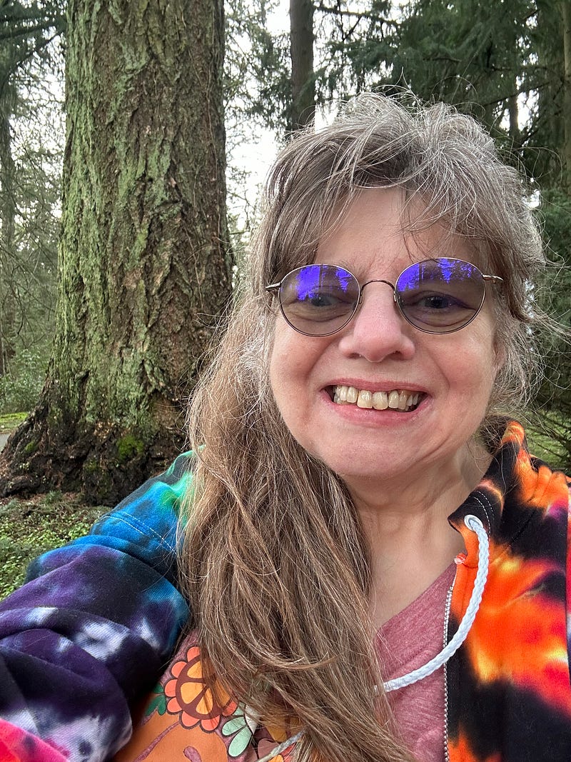 Selfie of the author with a beautiful Douglas fir tree behind me. Soon I’ll traverse on the woods trails once again!