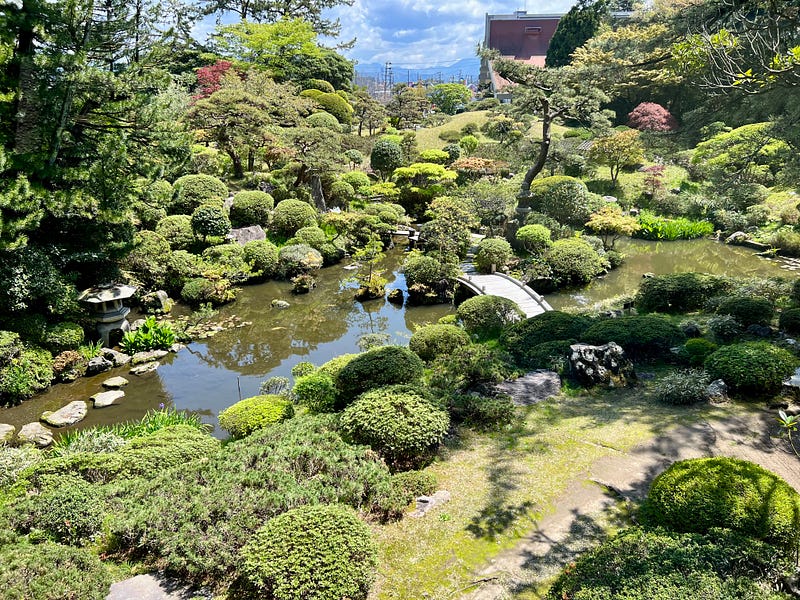 Japanese garden with pond and footbridge. Sakata, Yamagata.