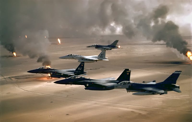 U.S. Air Force F-15s and F-16s fly over the burning oil fields of Kuwait. Airman Magazine via Flickr.