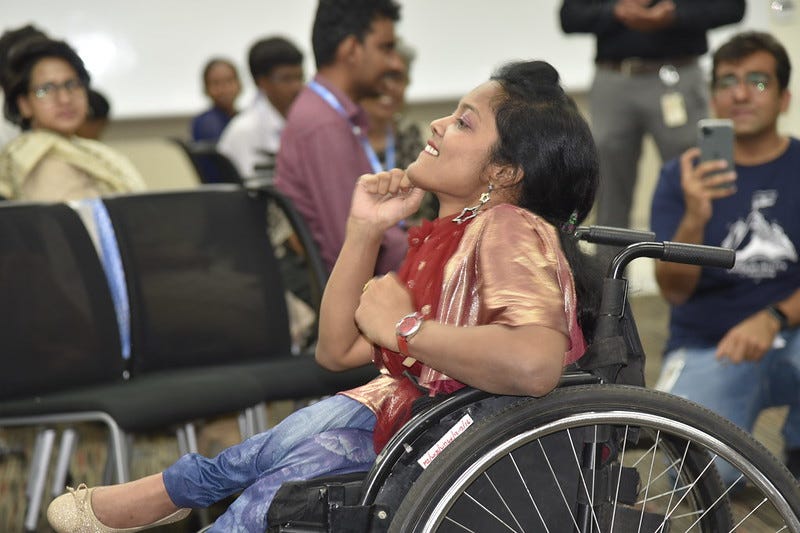 Woman dancing in wheelchair with audience