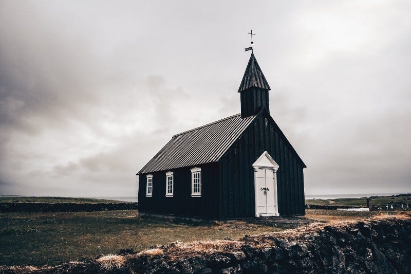 A black church with a white door