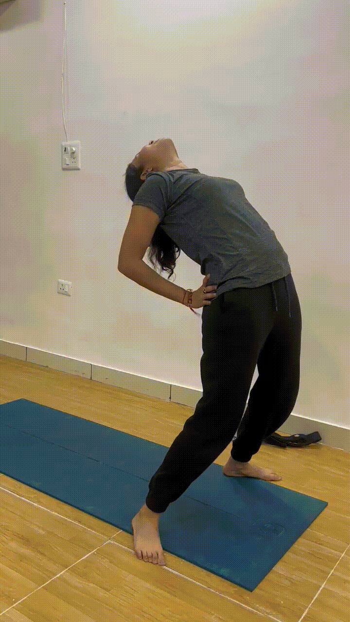A woman doing wheel pose.