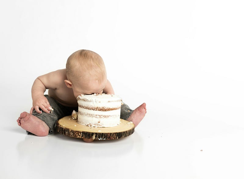 Toddler smashing his face on his birthday cake