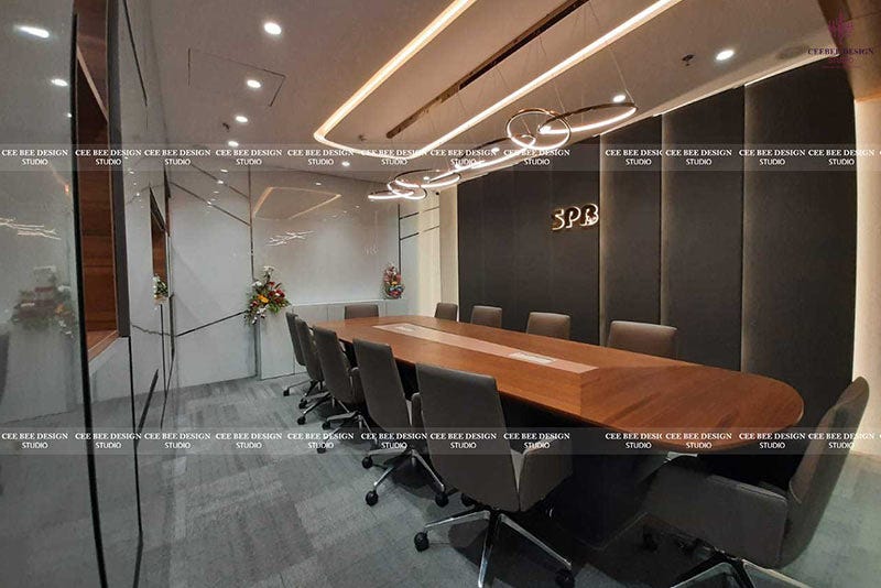 A well-designed conference room featuring a large table and chairs, exemplifying stylish office interior design.