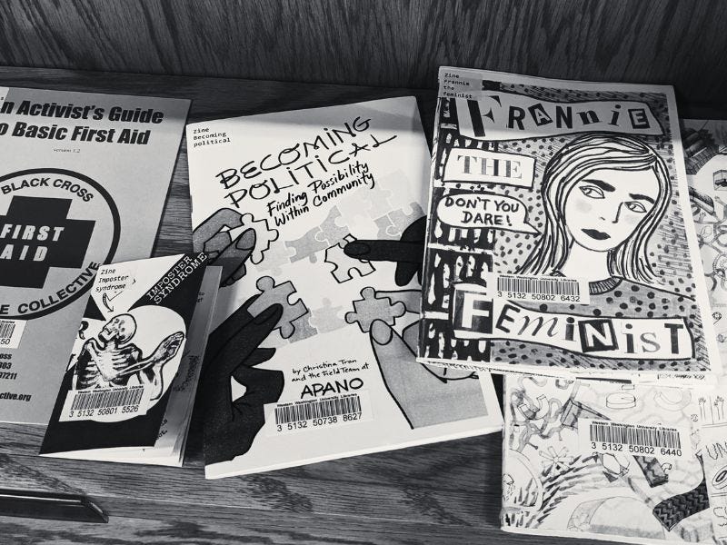 A spread of zines on a shelf at a library. One is titled ‘Frannie the Feminist.’
