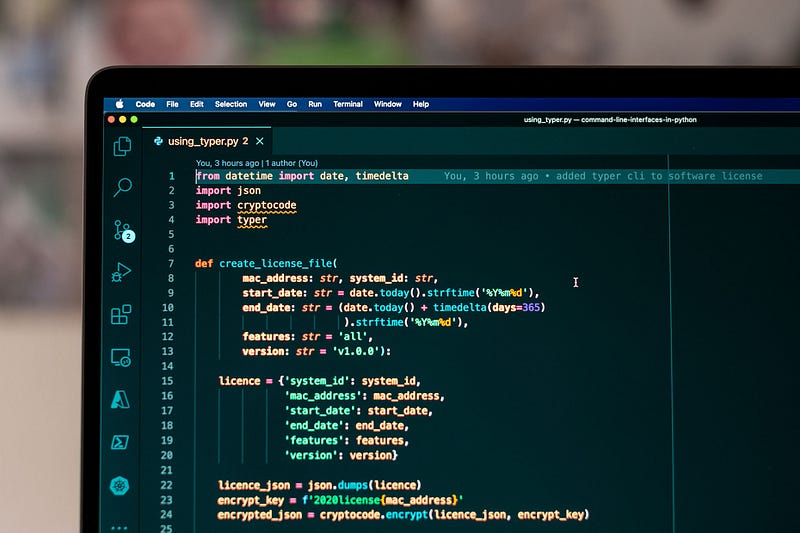 A photo of a MacBook running visual studio code that shows a Python script
