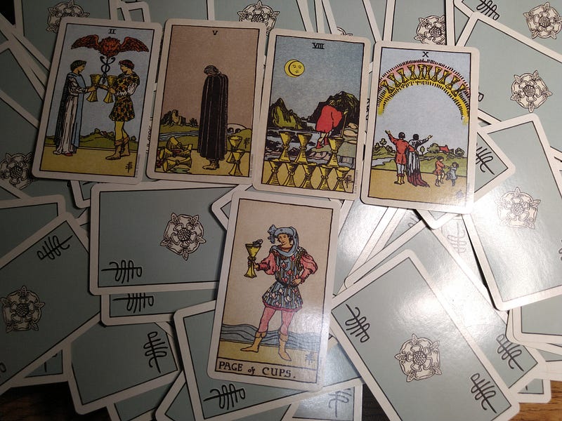 Two, Five, Seven, Ten, Page of Cups are pictured