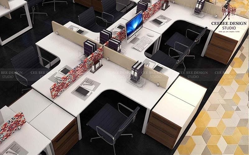 An office space with neatly arranged desks and chairs in a well-lit room, creating a professional and productive environment.