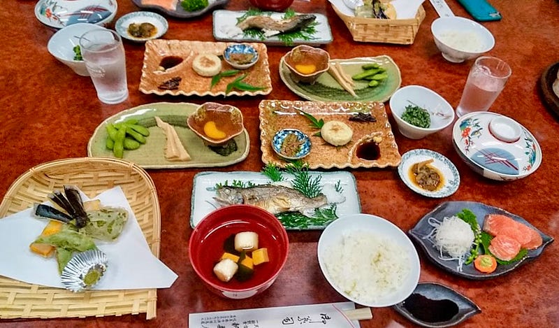 Multi-course meal laid out on small plates on a table. Which is the most exotic food?