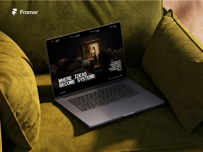 Laptop displaying a Framer website template on a cozy couch setting, featuring bold typography and a creative portfolio layout with the message “Where ideas become systems.
