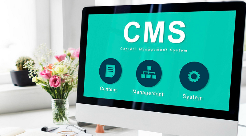Computer monitor displaying a CMS dashboard labeled “Content Management System.”