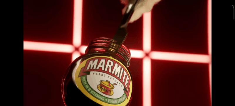 A GIF of a knife being dipped in a jar of Marmite repeatedly