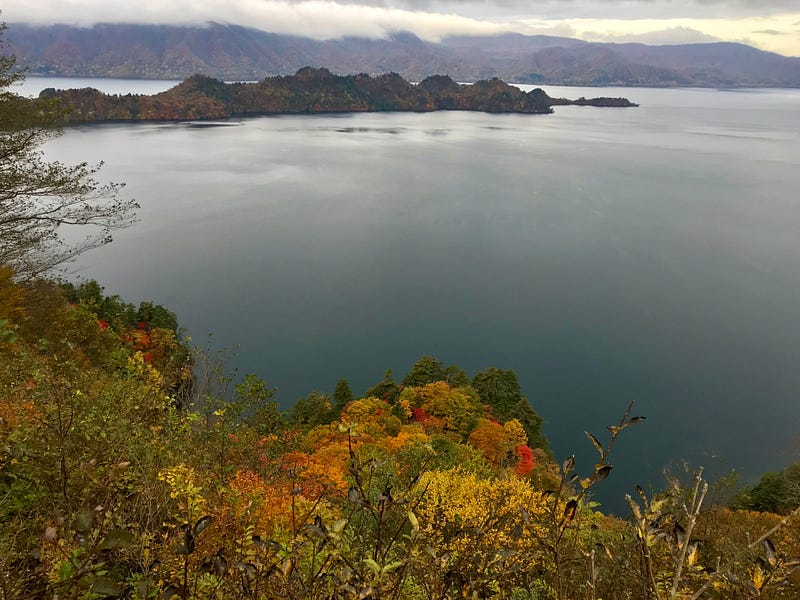 Lake Towada and one of the 2 peninsulas that form the ridge of the inner crater lake.