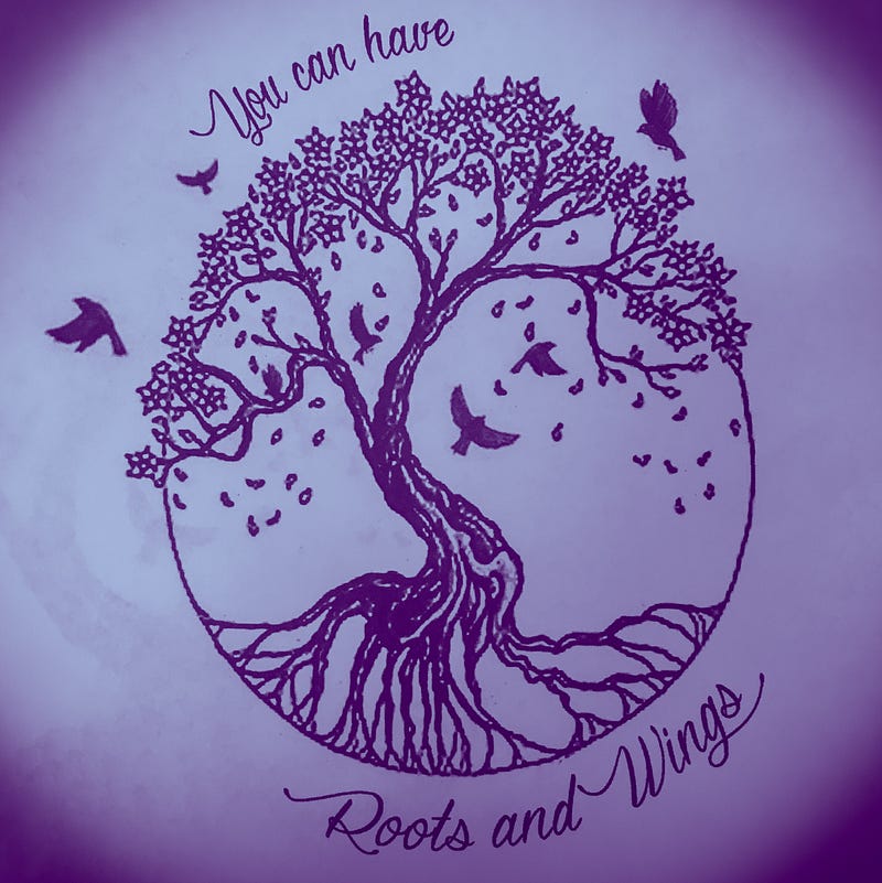 Photo of a line drawing a tree on a circle with roots and branches. In the branches, birds fly around. Around the top of the circle in calligraphy, it reads “You can have”, and along the bottom arch, “Roots and Wings.”