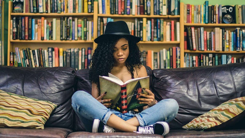 A woman on a couch reading a book