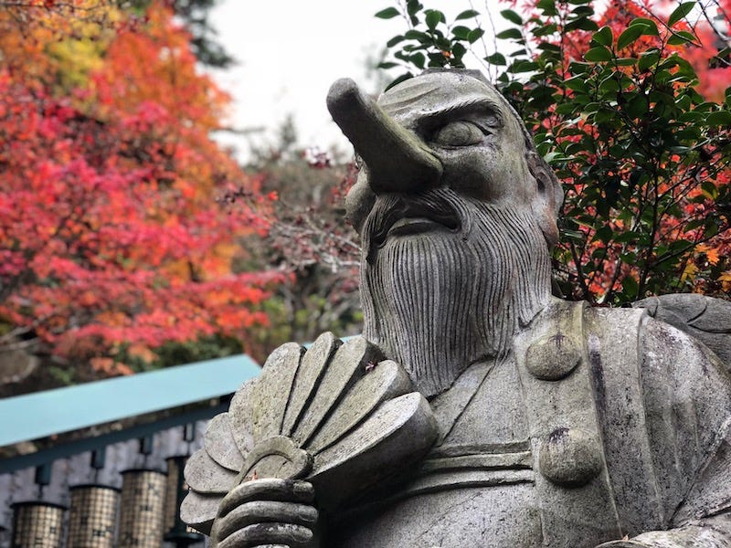 A statue of a tengu at Daisho-in during autumn on Hiroshima Prefecture’s island of Miyajima