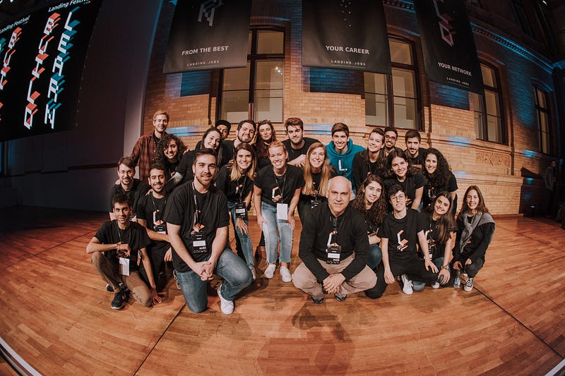 Fish eye picture of a group of people on a wooden stage