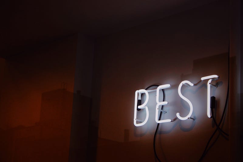 The word Best in neon, on a wall.