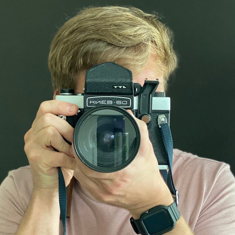 A photograph of Michael Elliott with his Kiev 60 Medium Format SLR camera.
