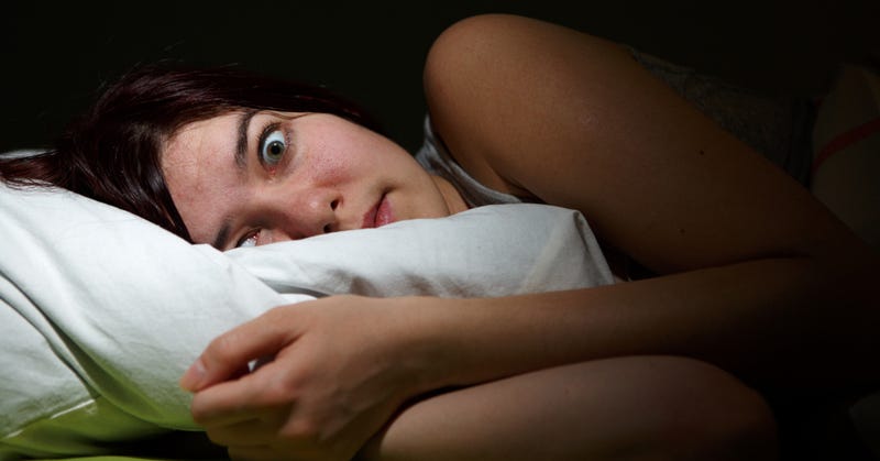 Woman wide awake in bed