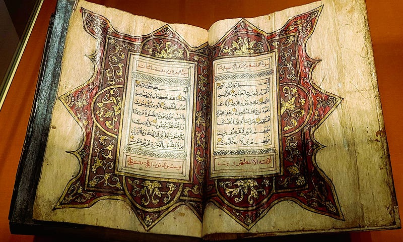 an open book with ancient writing and ornate inscriptions