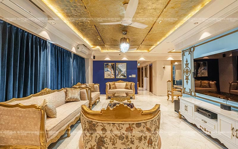 luxury living area with golden vibe furniture and ceiling light and tv mounted on wall