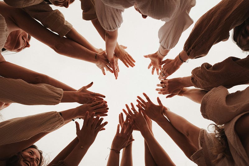 Many hands joining together on air to show a feel of community.