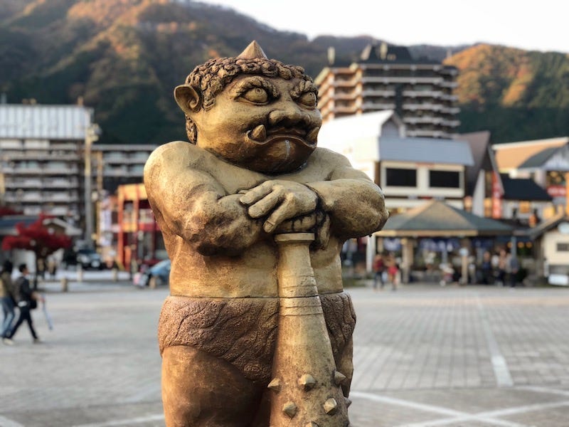 A golden oni statue stands outside Kinugawa Onsen Station to the north of Nikko