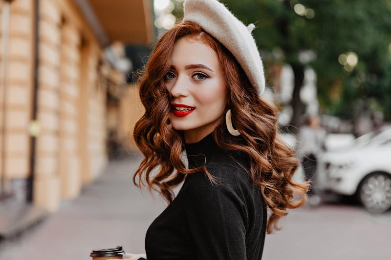 wonderful woman with red hair looking into camera.
