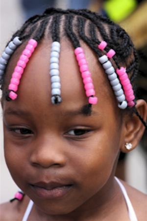Portrait of young Black girl with braided hair. 