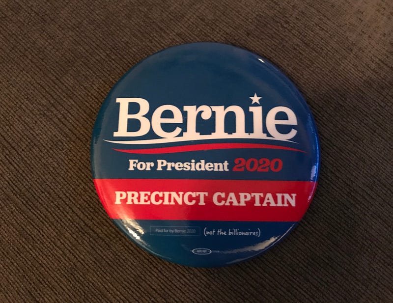 Photo of political campaign button that reads: “Bernie For President 2020 Precinct Captain” taken by author (Joyce O’Day).