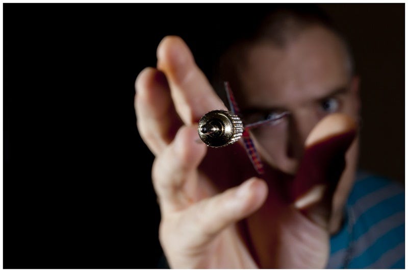 How to solve the dartboard paradox? — An image of a dart-tip heading towards the camera.