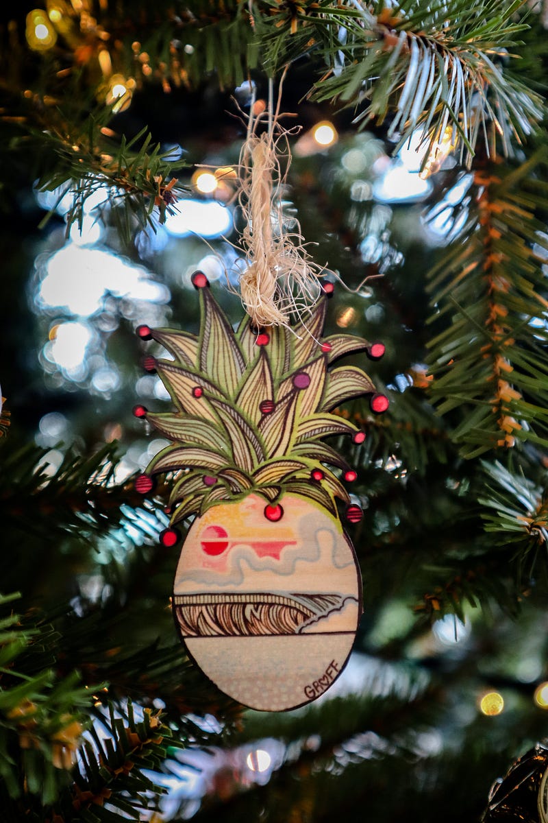 Christmas decoration in form of an ananas hanging on a Christmas tree.
