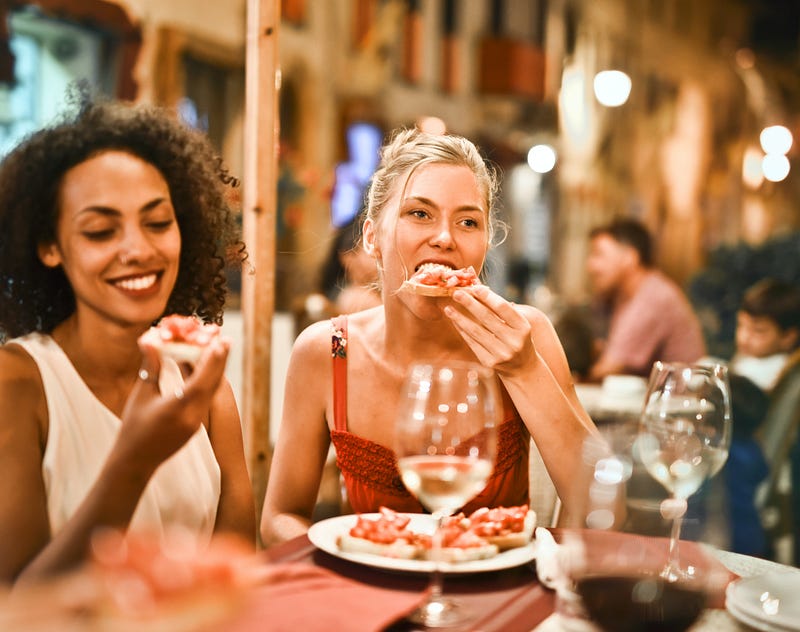 A woman eating pizza.