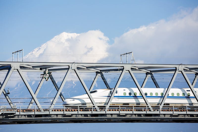 A bullet train rushes past Mt. Fuji in Japan en route to Fujisan Hongu Sengen Taisha