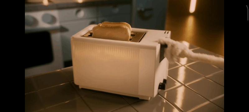 A GIF of one puppet lifting a slice of toast