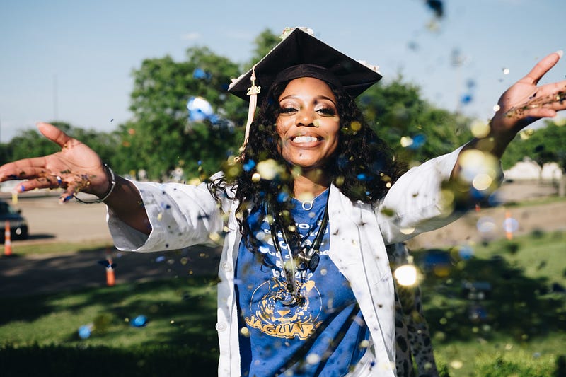 Black Woman Wearing a Mortar Throwing Confetti — Photo by Joshua Mcknight from Pexels