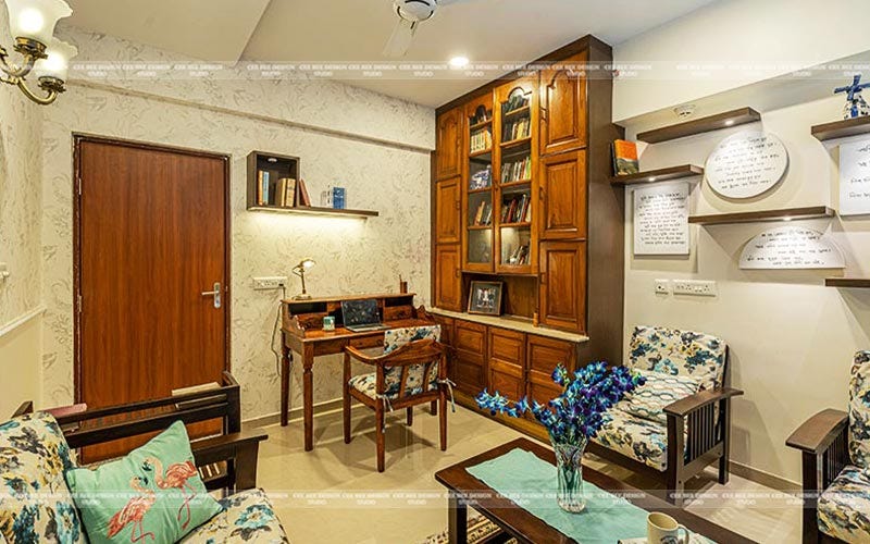 a cozy living room with a desk chair and bookshelf perfect for work or relaxation.