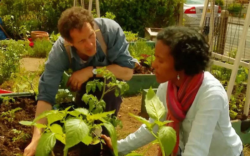 Monty Don and a show participant gardening together.