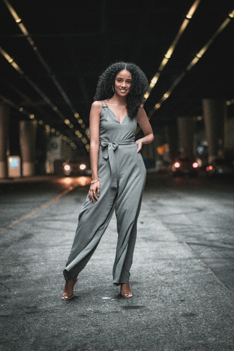 a woman wearing a gray jumpsuit