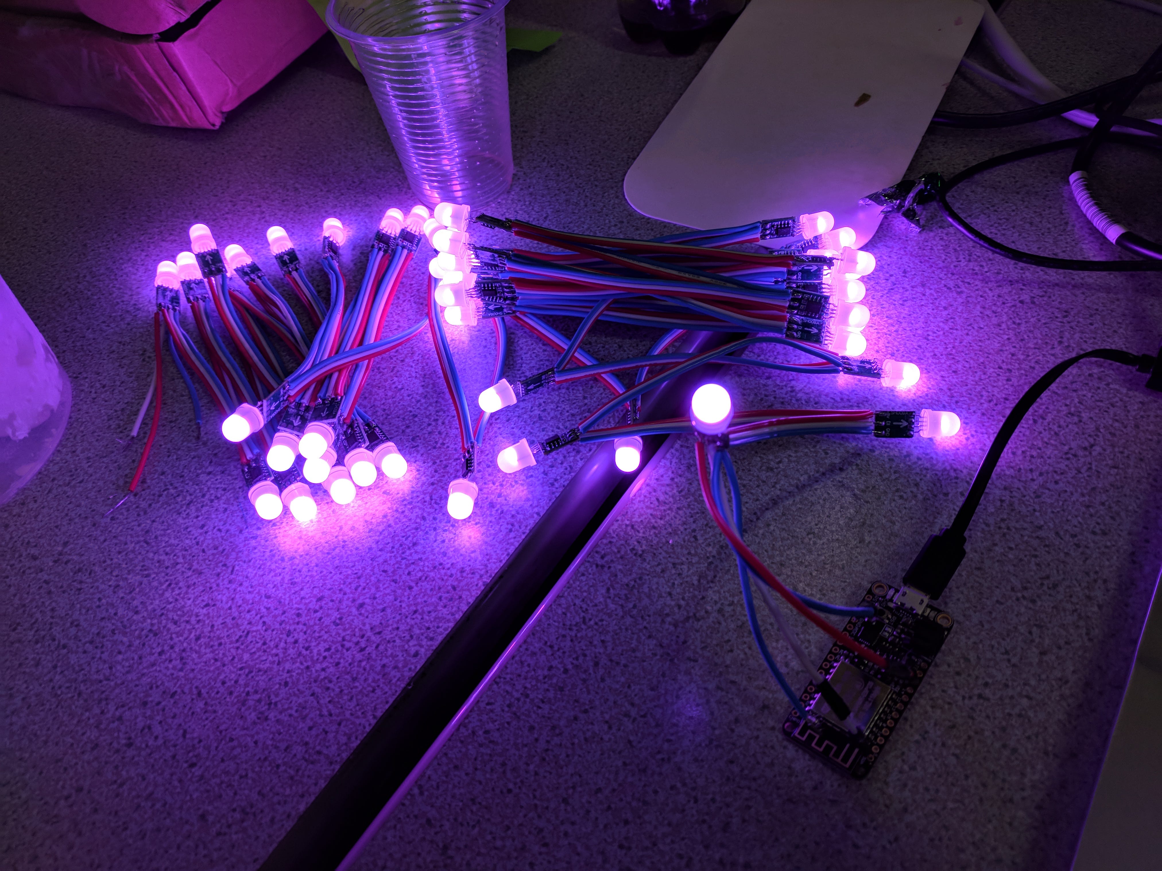 My first attempt at RGB LEDs and the Adafruit Feather, set up while at SexTechHack. These lights were way too heavy to put in a dress so I then decided to go for individual pixel LEDs.