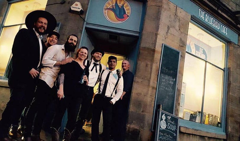 Photo of The Dead South & Danny Olliver outside the Bluebird Cafe in Edinburgh, with it’s owner Scone McGregor and a distinguished regular. May 2016