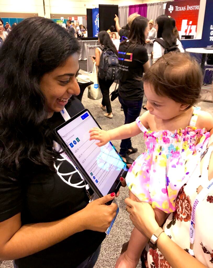 woman holding ipad, baby touching ipad